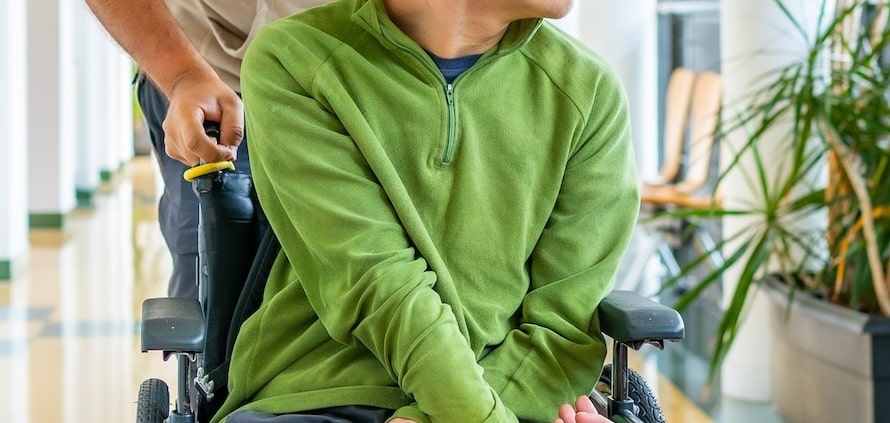 Stock image of man and his carer outside