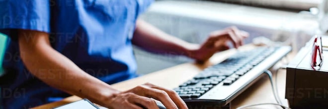 nurse using email on a PC at work